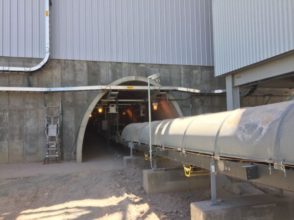 Tunnel below building with a large pipe running through