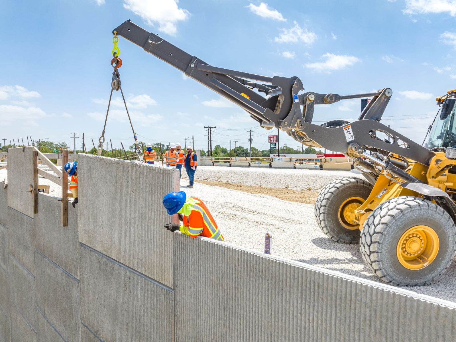 construction site workers setting MSE panel