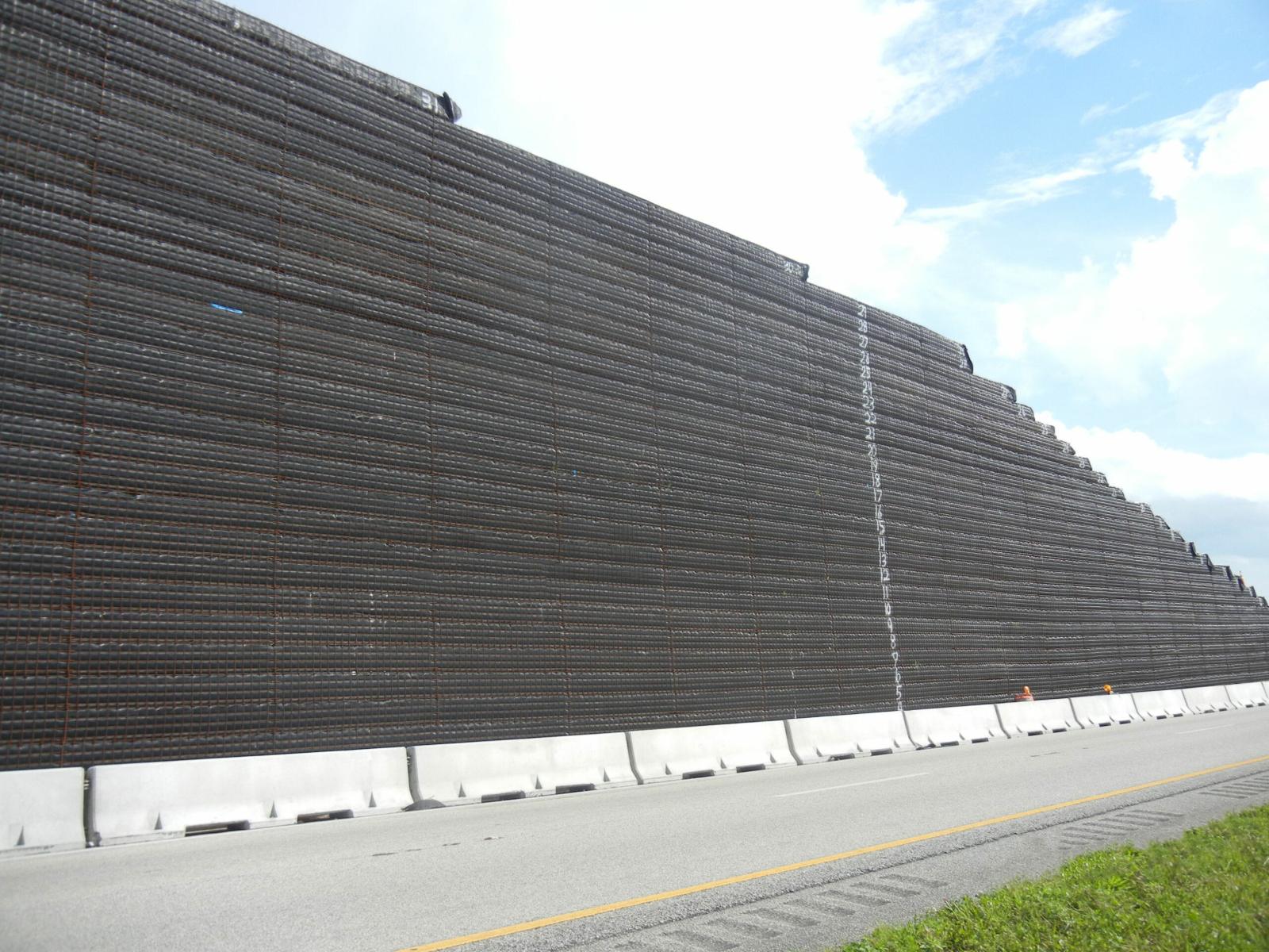 temporary wire mesh retaining wall next to roadway